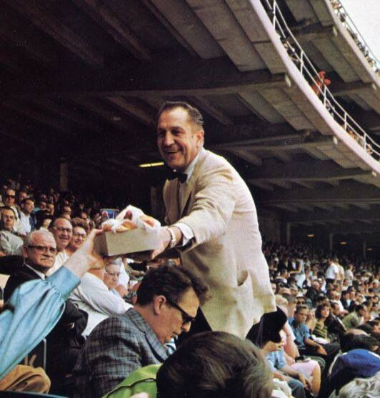 Vincent Price giving his friend hot dogs at a Dodgers game.